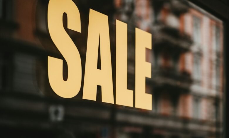 yellow sale text printed on glass window