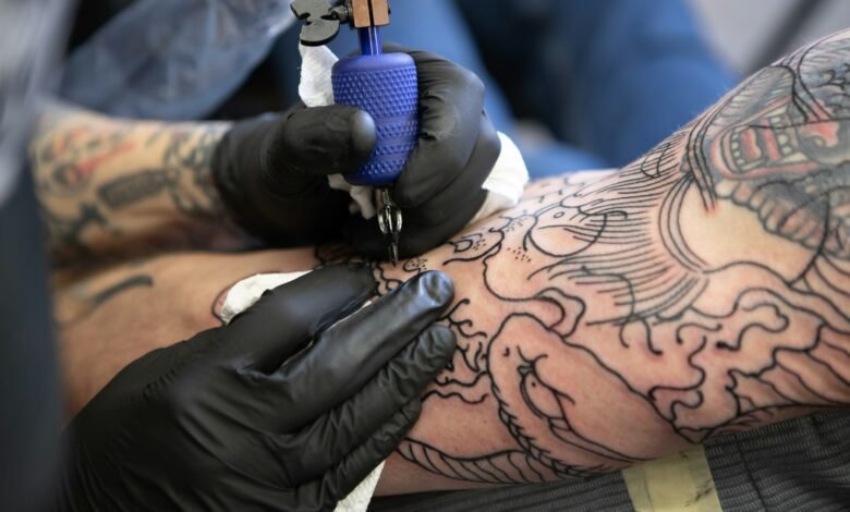 A young man gets a tattoo cover-up.