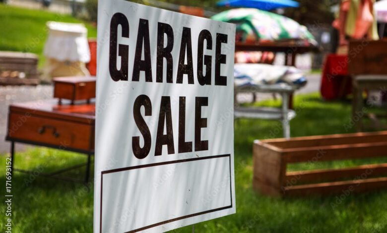 Garage sale sign on the lawn of a suburban home