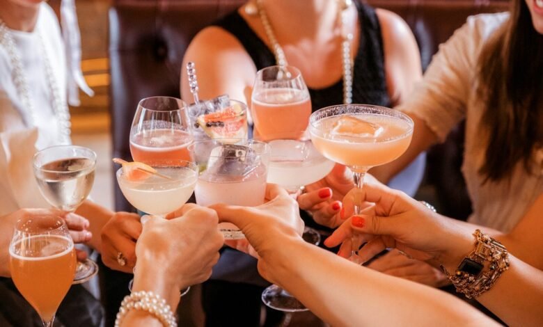 woman in black tank top holding clear wine glass