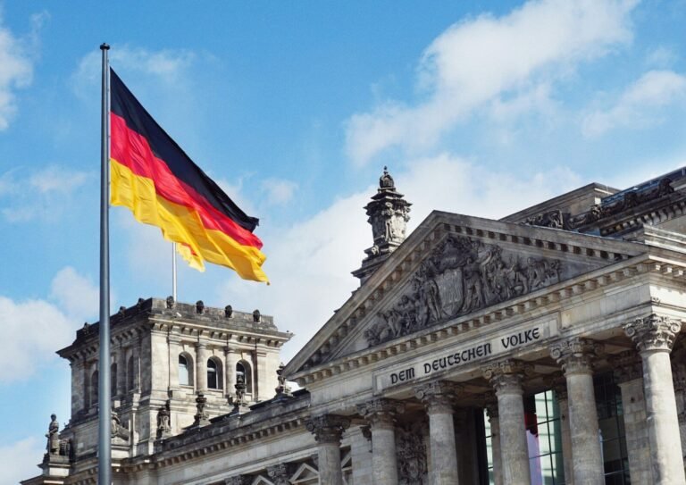 The German flag flying above the Reichstag building in Berlin, Germany