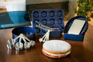 A table topped with a muffin next to a cookie pan
