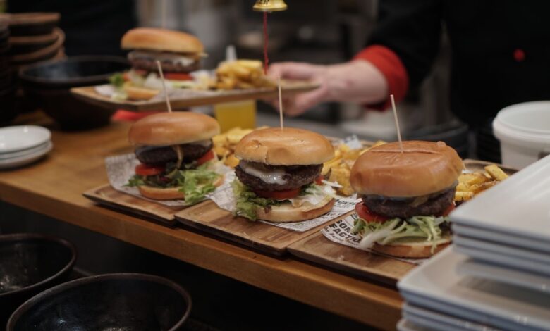 Juicy gourmet burgers with fries ready to serve in a cozy restaurant setting.